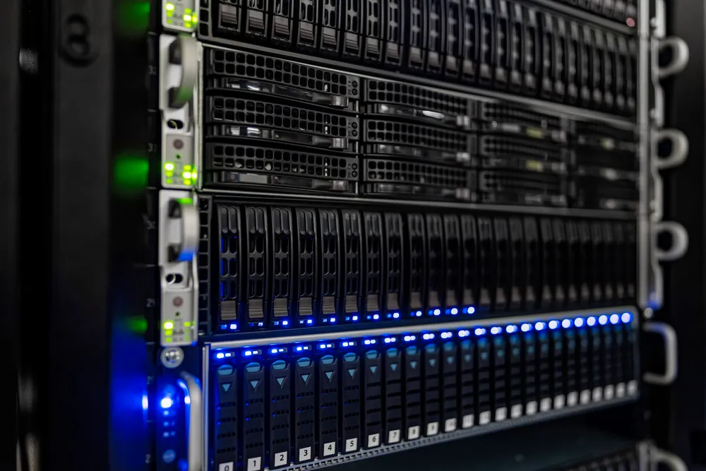 Rows of server hardware with blue and green indicator lights at NOIRLab headquarters.