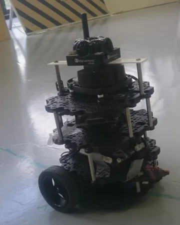 A wheeled TurtleBot3 mobile robot with stacked electronics on a laboratory floor.